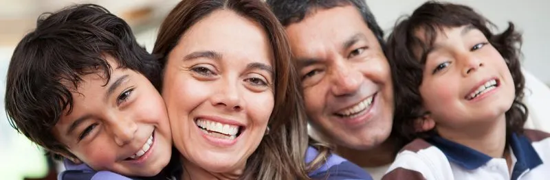 Smiling family showing their healthy teeth